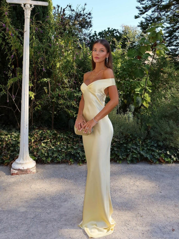 Chic women's off-shoulder maxi wedding guest dress. Elegant gold formal gown perfect for special occasions & parties.