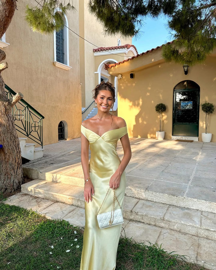 Gold elegant off-shoulder maxi dress for women. Chic formal evening gown, ideal for wedding guests & party events.