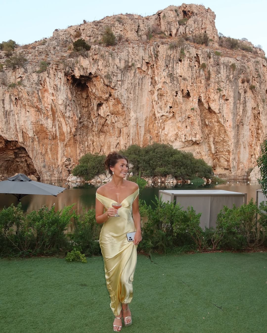 Stylish women's off-shoulder gold maxi dress. Chic formal evening gown with a bias cut, ideal for wedding guests.