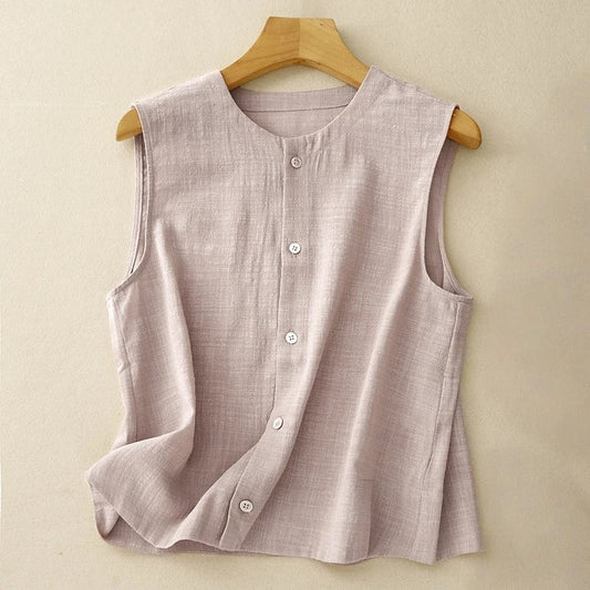 Chic women's sleeveless asymmetrical top in light pink, perfect for elegant summer fashion. Features modern button detail.