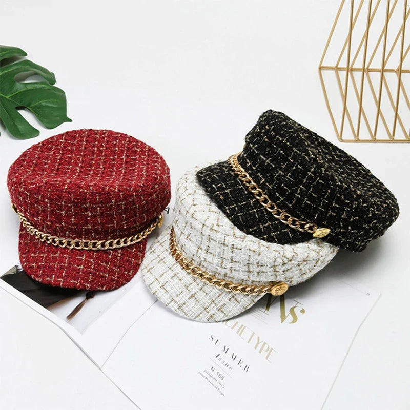 Chic women's tweed cap featuring a sophisticated gold chain accent, perfect for a stylish fashion statement.