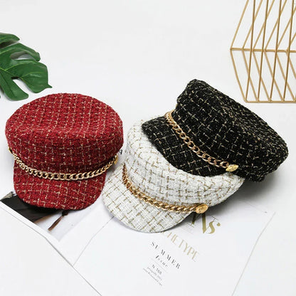 Chic women's tweed cap featuring a sophisticated gold chain accent, perfect for a stylish fashion statement.
