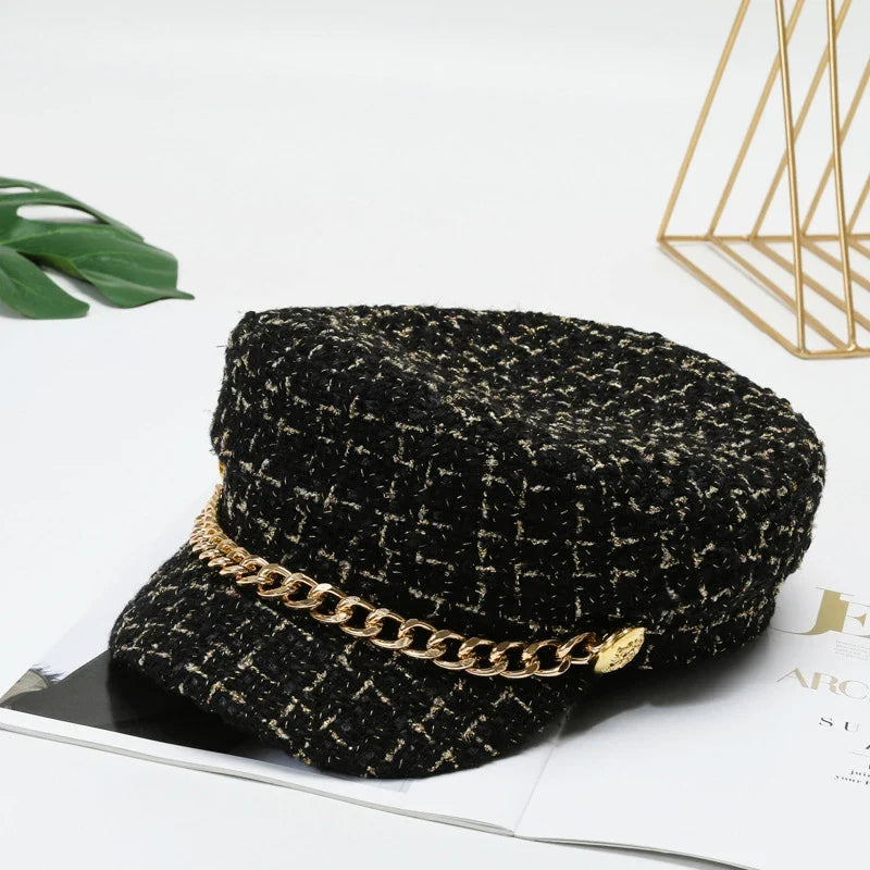 Fashion-forward women's tweed cap with gold chain accent, a chic statement accessory to elevate any outfit.