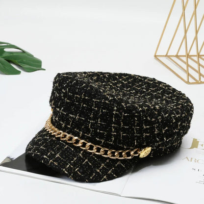Fashion-forward women's tweed cap with gold chain accent, a chic statement accessory to elevate any outfit.