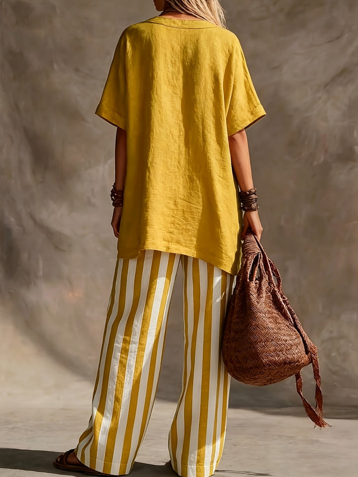 Women's summer outfit: Comfortable V-neck short sleeve top and fashionable striped wide-leg pants. Vacation style.