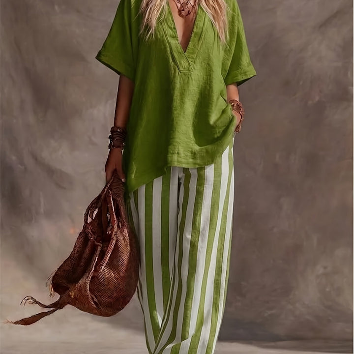 Vacation ready women's outfit: Short sleeve V-neck top & eye-catching striped wide-leg pants. Modern matching set.