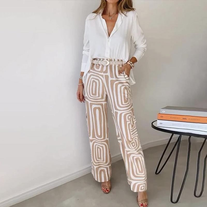 Chic women's two-piece set with a flowing top & elegant patterned trousers for versatile day to night wear.