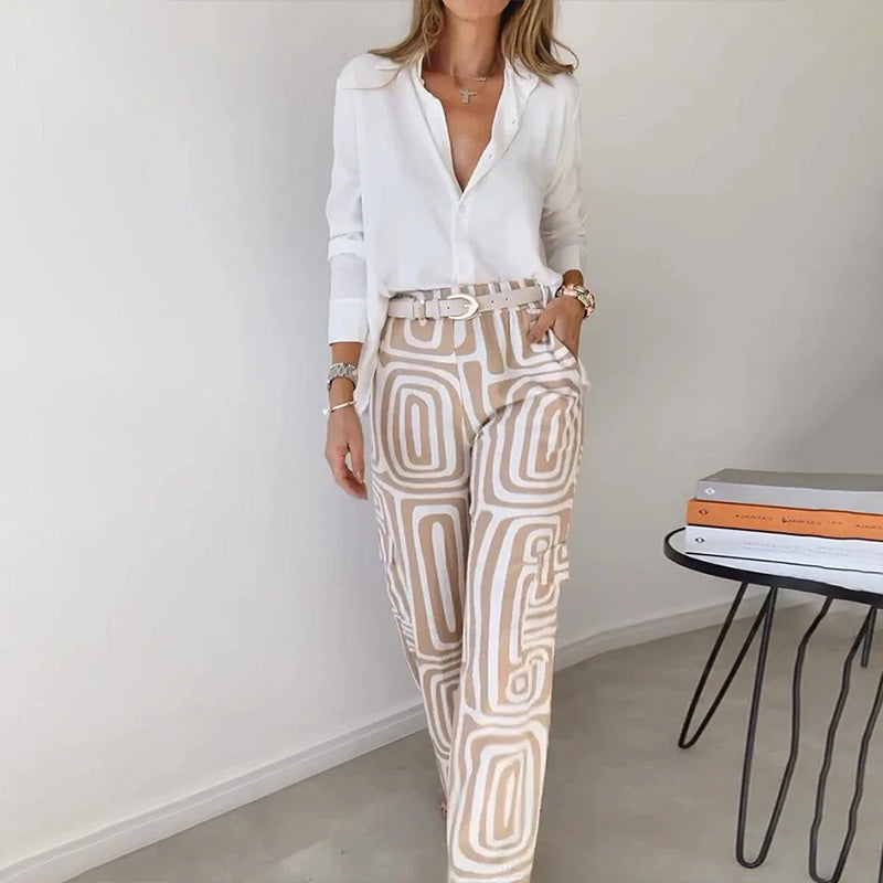 Women's elegant two-piece outfit: flowing top paired with patterned trousers for a sophisticated, comfortable look.