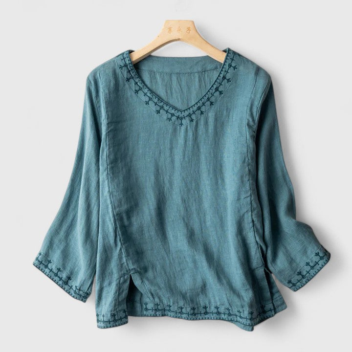 Chic women's v-neck blouse, elegant & versatile for office or casual wear. Relaxed fit, long sleeves.