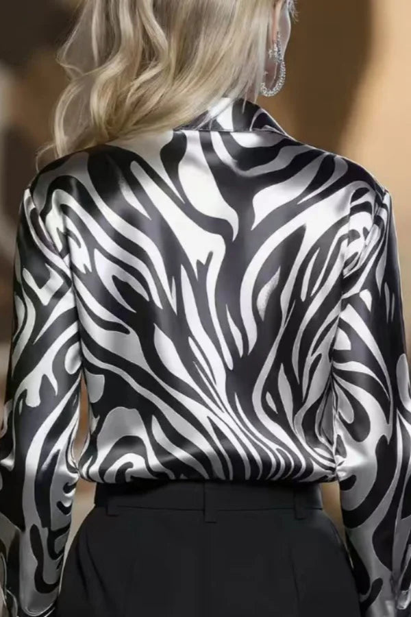 Stylish women's long sleeve zebra print button-down shirt, a chic blouse ideal for sophisticated office or evening wear.
