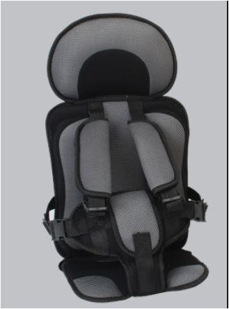 Portable travel car seat booster installed in a car, providing toddler safety with child harness.