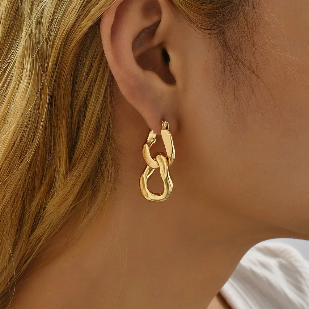 Stylish women's chunky gold link drop earrings, perfect for modern jewelry trends.