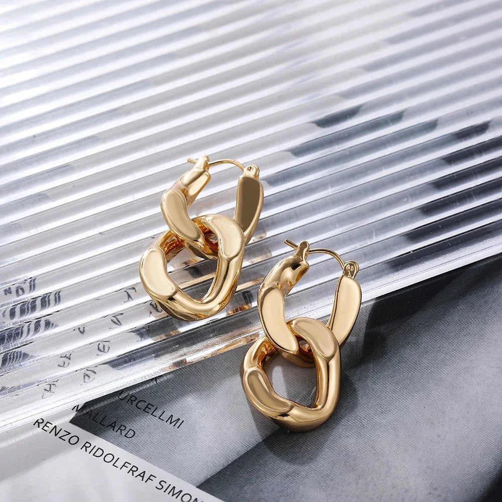 Elegant chunky gold link drop earrings, a fashionable jewelry accessory for women.