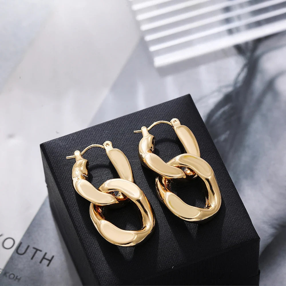 Women's chunky gold link drop earrings, a dazzling accessory elevating any look.