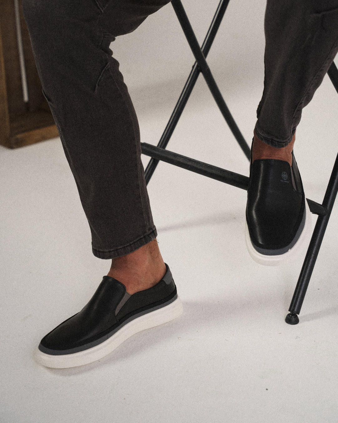 Stylish men's white leather slip-on shoes, offering classic comfort and a sleek casual look.