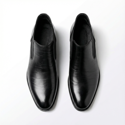 Side profile of men's brown leather Chelsea boots, emphasizing classic silhouette and smooth finish.