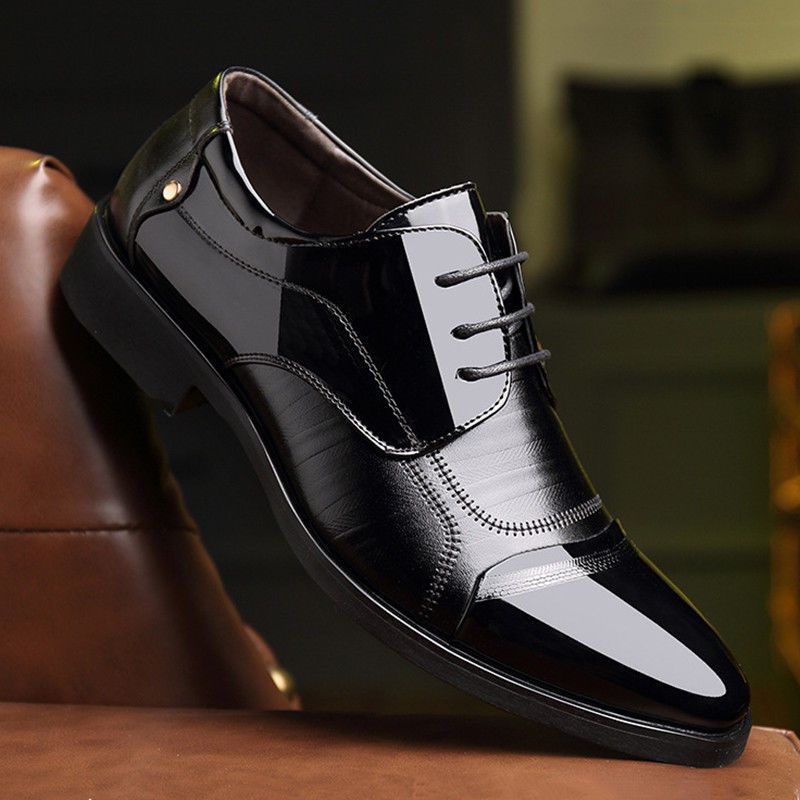 Detailed shot of men's black Oxford dress shoes, highlighting the elegant lace-up design.
