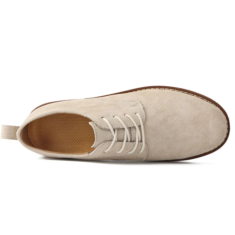 Detail shot of men's elegant Oxford dress shoes, highlighting quality leather texture & refined stitching.