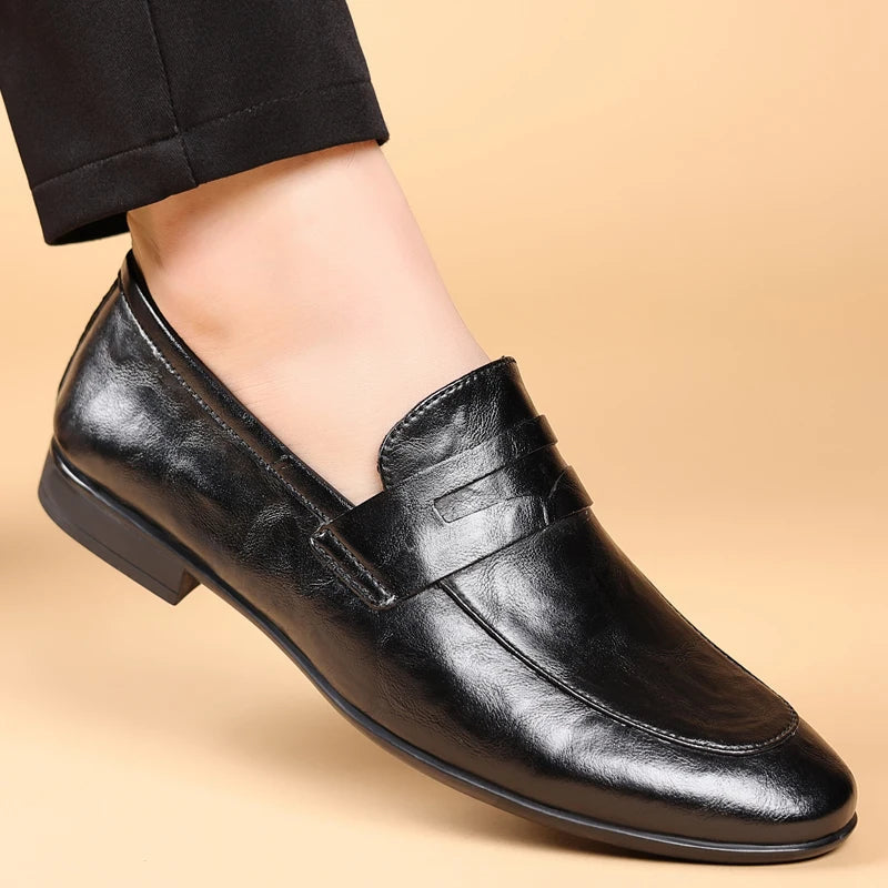 Classic men's brown leather dress loafers, professional slip-on footwear with timeless appeal.