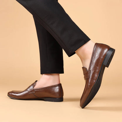 Stylish brown leather slip-on loafers for men, offering comfort and a professional aesthetic.