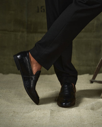 Polished brown leather slip-on loafers, perfect men's footwear for formal or business casual.