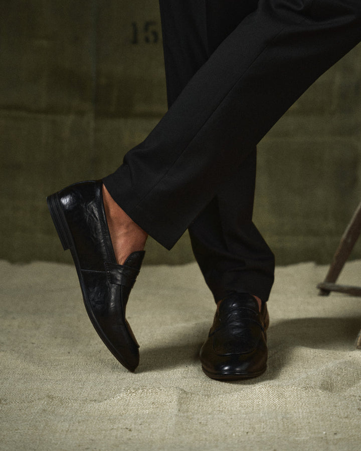Polished brown leather slip-on loafers, perfect men's footwear for formal or business casual.