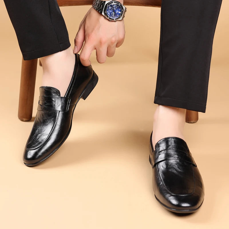 Comfortable men's brown leather slip-on dress shoes, essential for a classic professional style.
