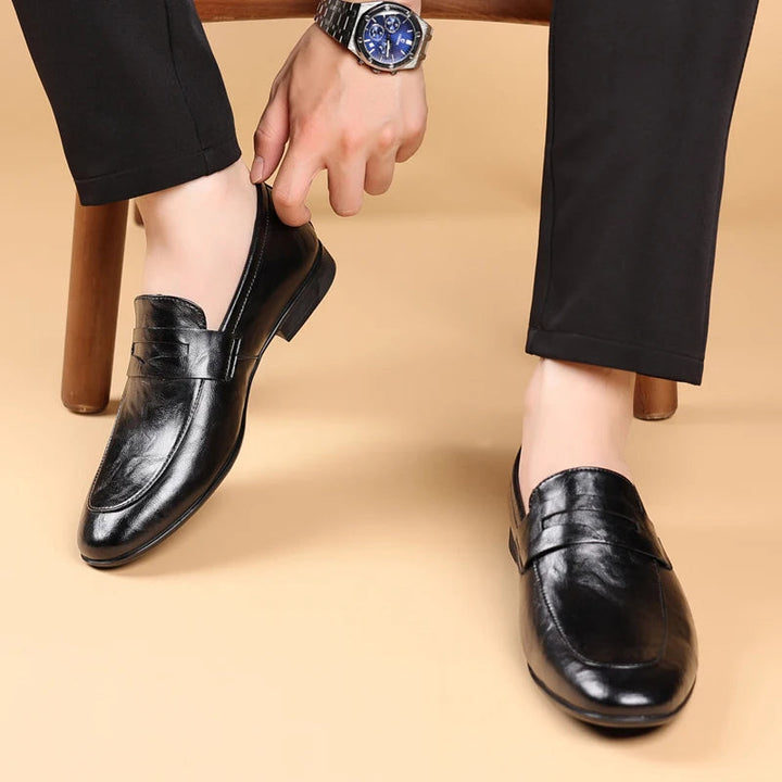 Comfortable men's brown leather slip-on dress shoes, essential for a classic professional style.