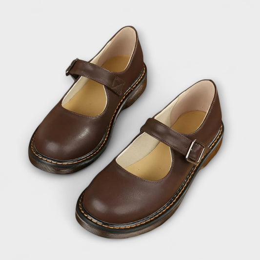 Classic black women's Mary Jane flat shoes with adjustable buckle for comfortable, everyday wear.
