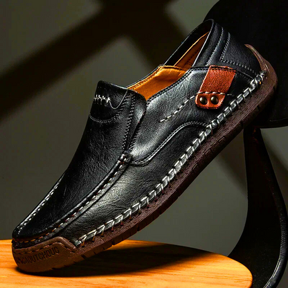 Close-up of comfortable men's classic leather slip-on loafers with elastic goring, perfect for all-day wear.