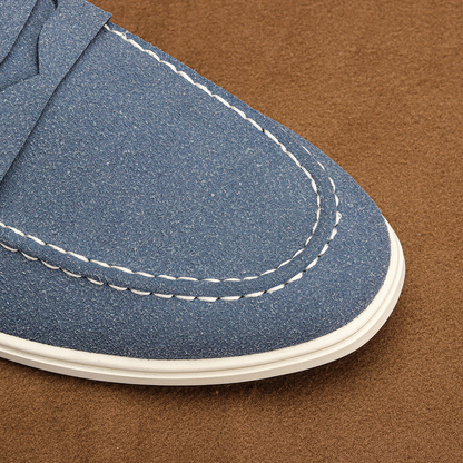 Close-up: Men's penny loafer shoe, showcasing elegant design, quality leather & comfortable construction.