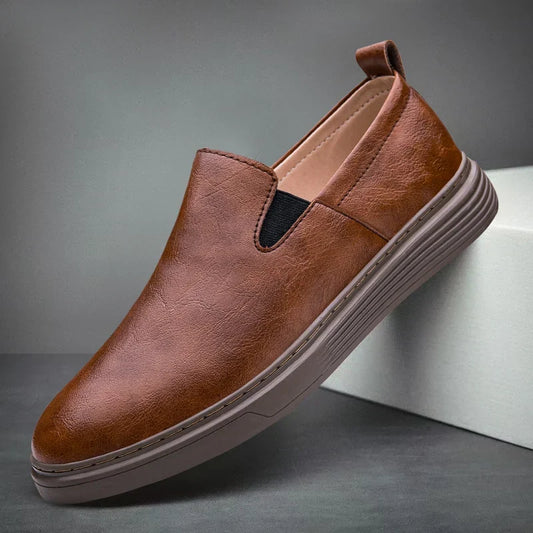 Classic men's brown slip-on dress loafers. Timeless and comfortable men's footwear, perfect for formal or casual wear.