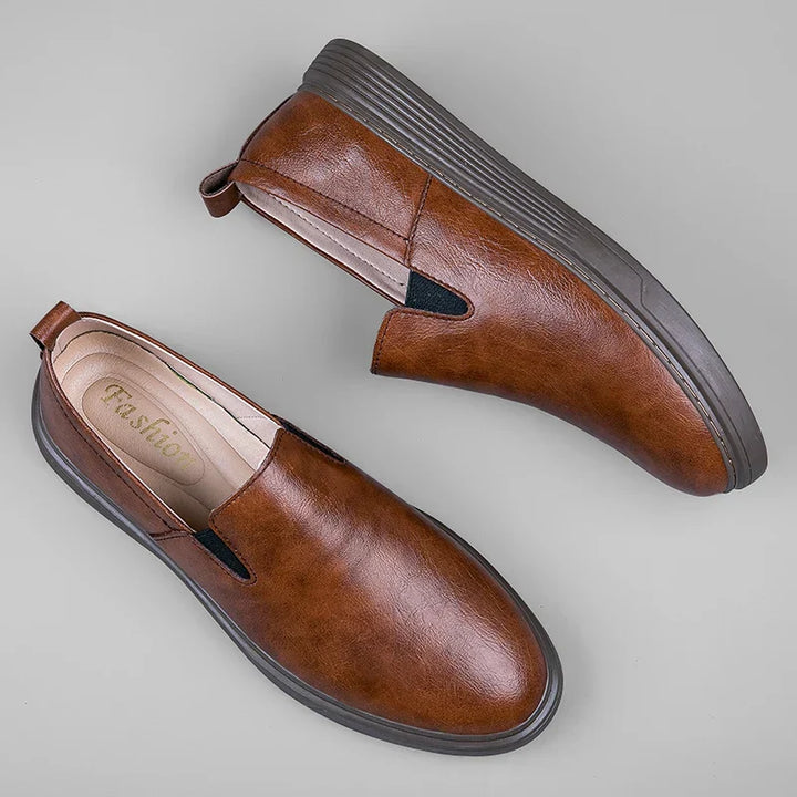 Comfortable black men's slip-on loafers, ideal dress shoes for business or casual outfits. Classic footwear.