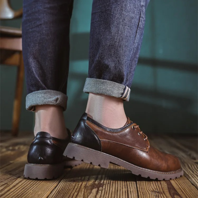 Man wearing versatile Men's Cedar Ridge Oxford shoes, suited for business or leisure.