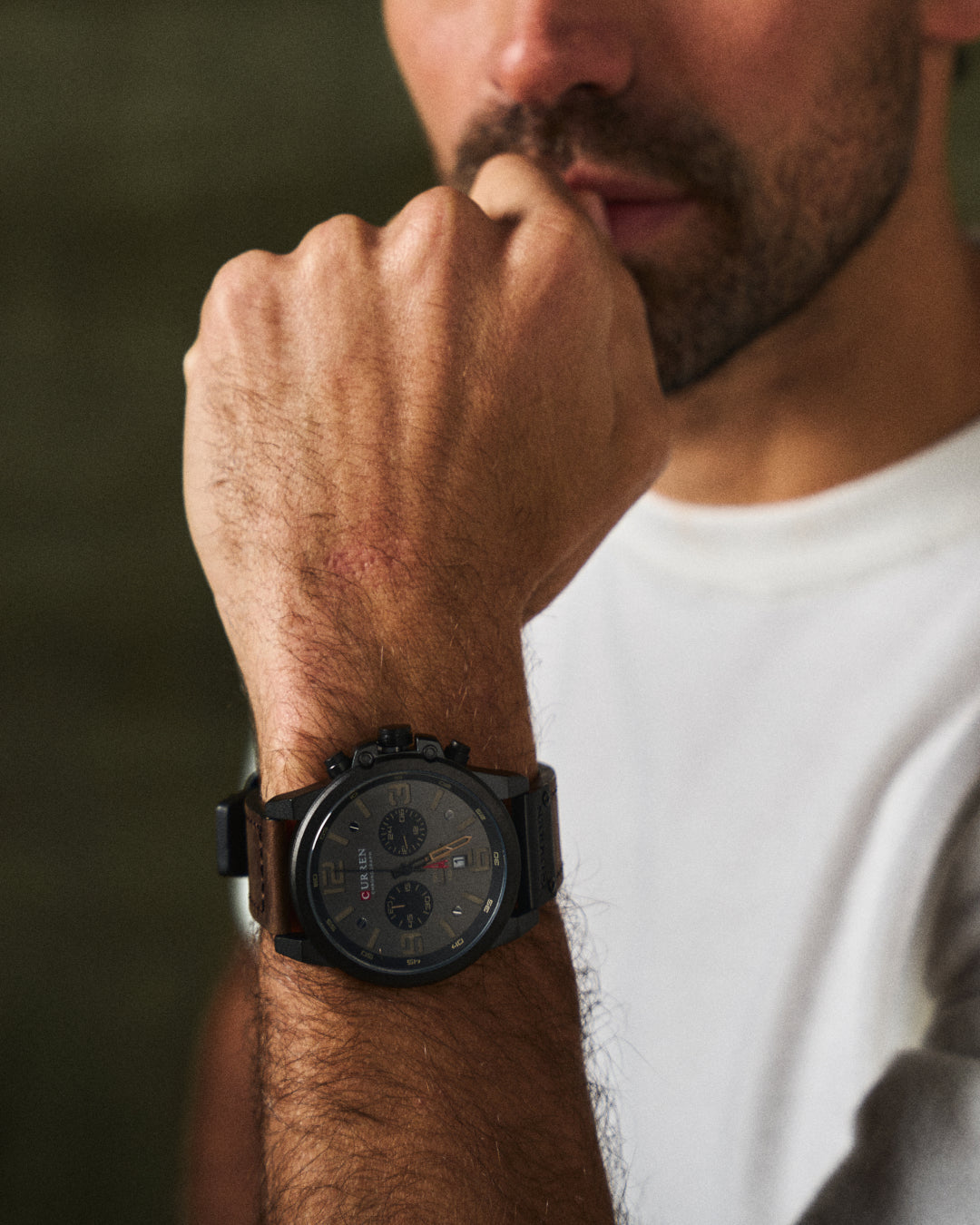 Stainless steel men's chronograph watch, black leather band, water-resistant for daily wear.