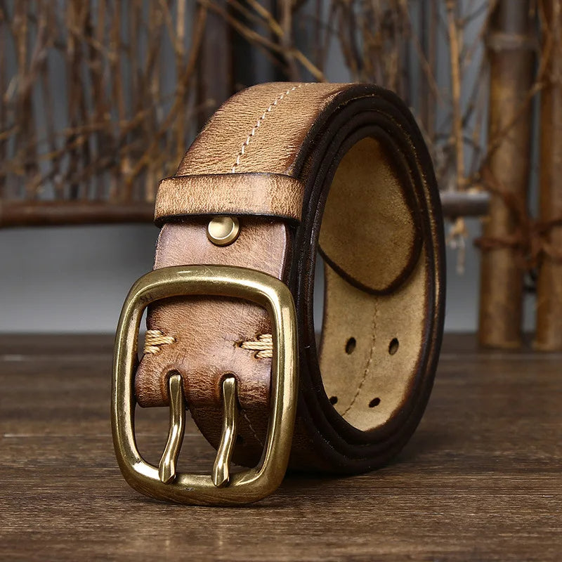 Versatile black full-grain leather men's belt, complementing dress pants for a sophisticated appeal.