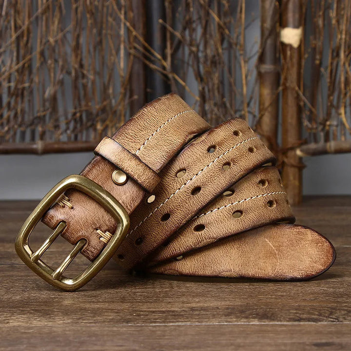 Polished brass buckle on a classic men's full-grain leather belt, showcasing quality and design.