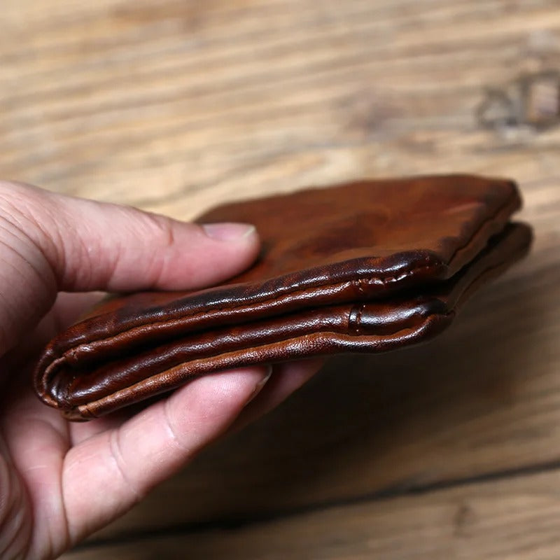 Men's durable full-grain leather bifold wallet with a classic, vintage aesthetic.