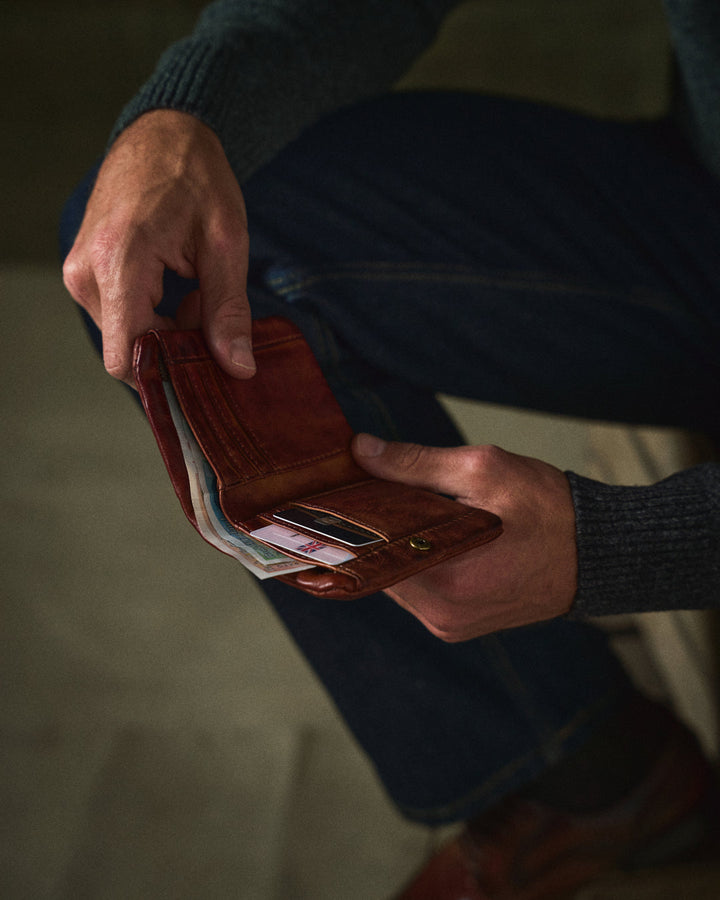 Rich brown full-grain leather bifold wallet for men, offering classic style and durability.