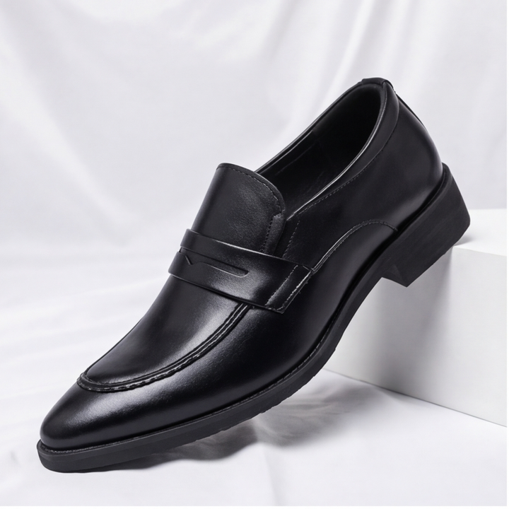 Man wearing classic brown penny loafers, showcasing stylish and comfortable everyday footwear.