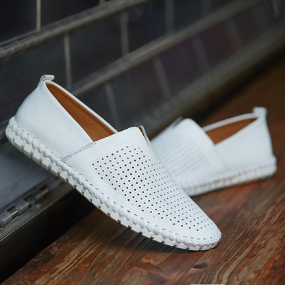 High-quality men's slip-on loafers with classic perforated detail, a versatile wardrobe staple.