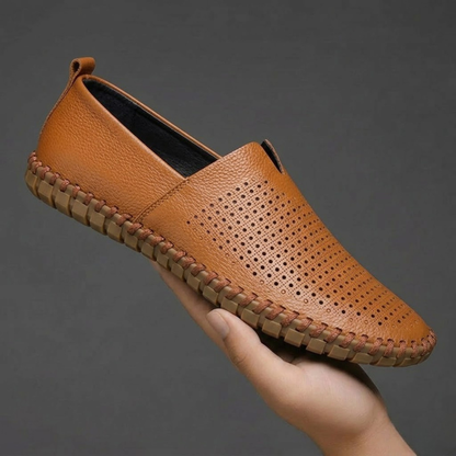 Close-up of the perforated texture on men's classic slip-on loafers.