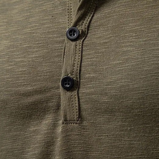 Model wearing a black slim-fit men's henley shirt, showcasing its modern men's fashion appeal.