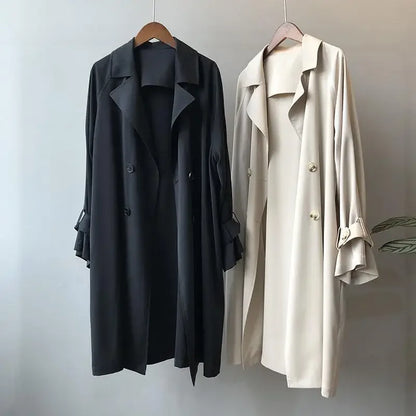 Long classic women's trench coat with double-breasted design, essential elegant outerwear for fall & spring.