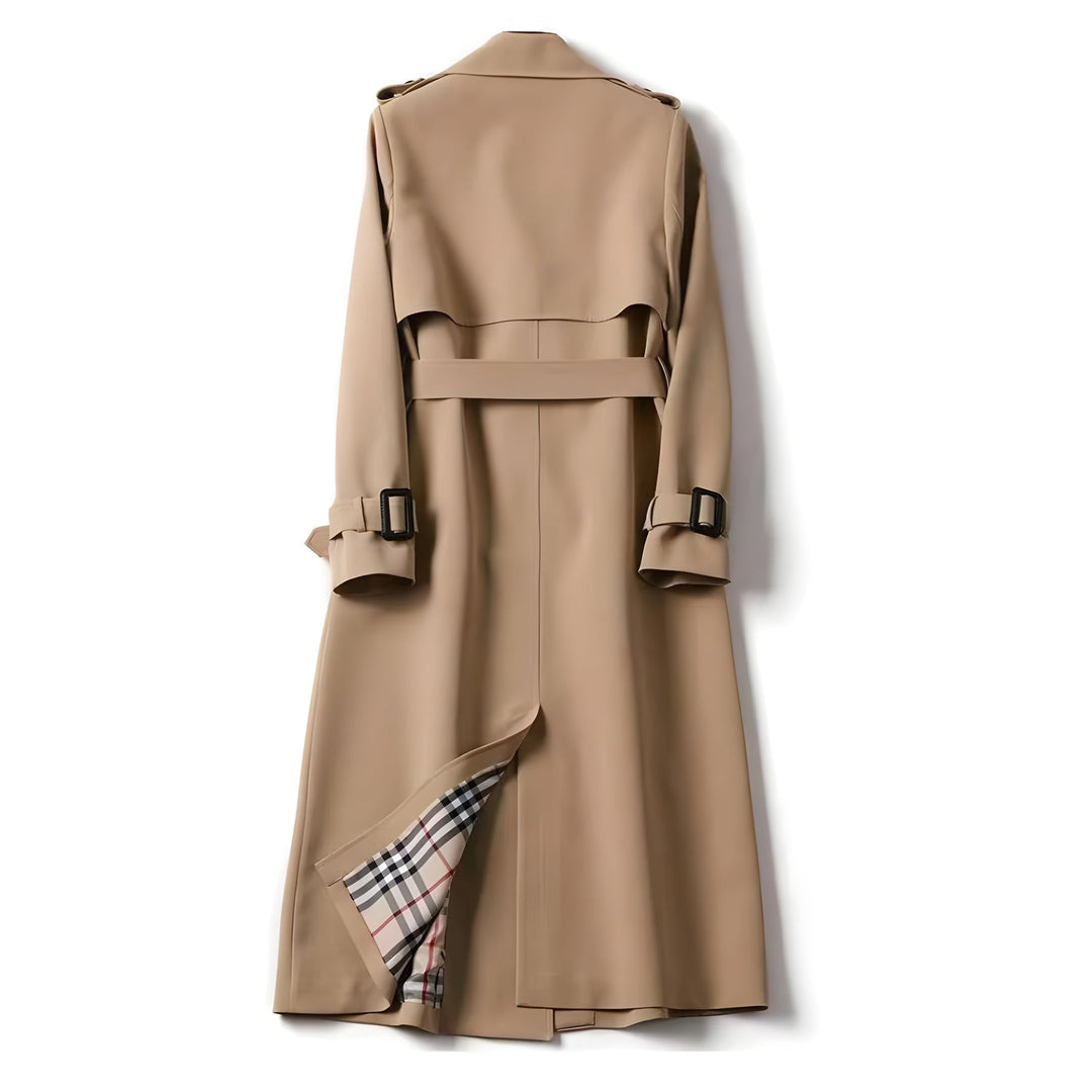 Woman walking in a beige double-breasted trench coat, belted for a cinched waist, water-resistant outerwear.
