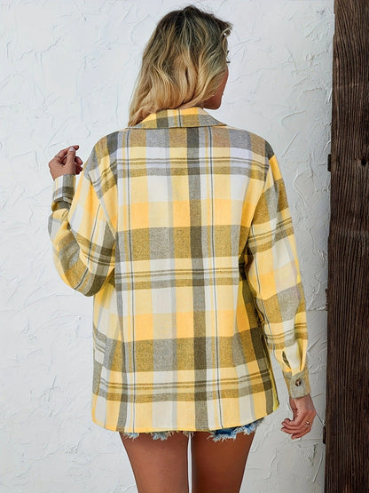 Women's classic plaid shirt, buttoned front, long sleeves rolled up for a relaxed, casual vibe.