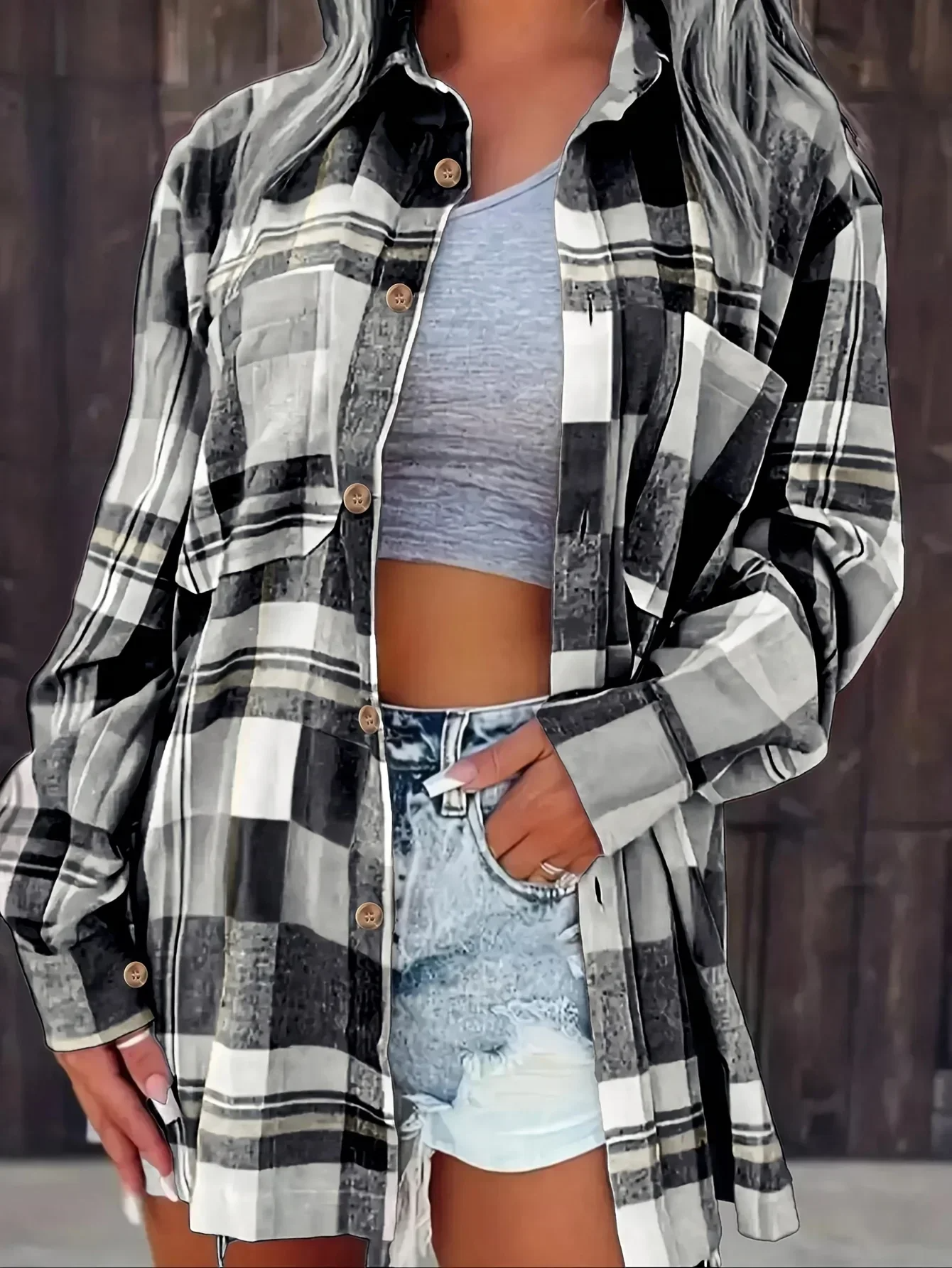 Detailed view of women's plaid button-down shirt fabric and button closure, quality casual wear.