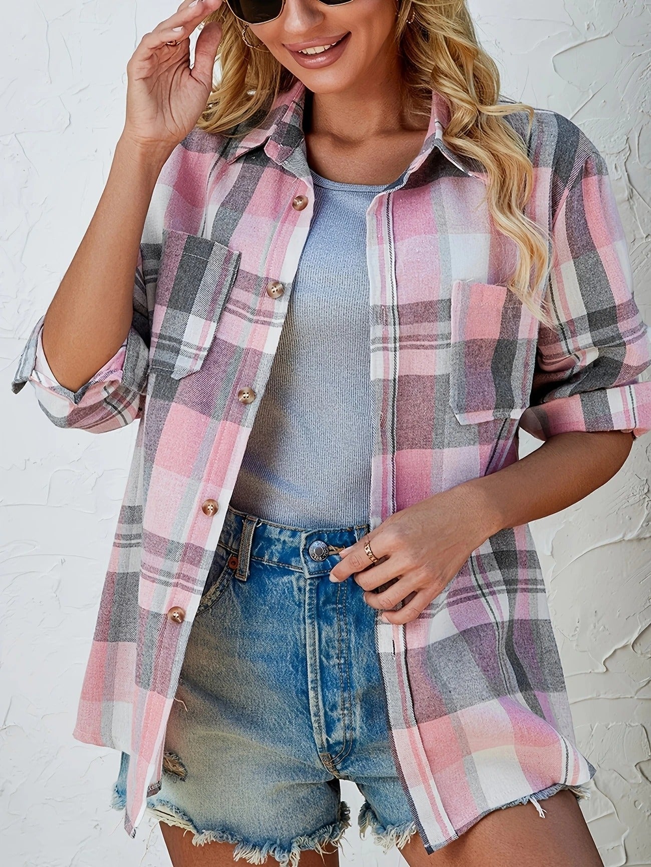 Comfortable women's blue plaid button-down shirt, versatile for stylish everyday outfits.