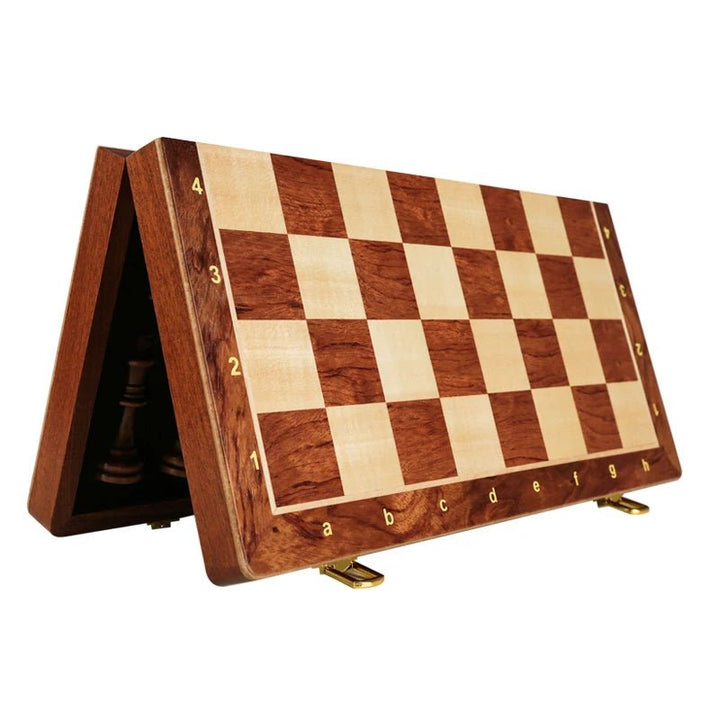 Complete wooden chess set featuring a foldable walnut board and weighted chess pieces for play.