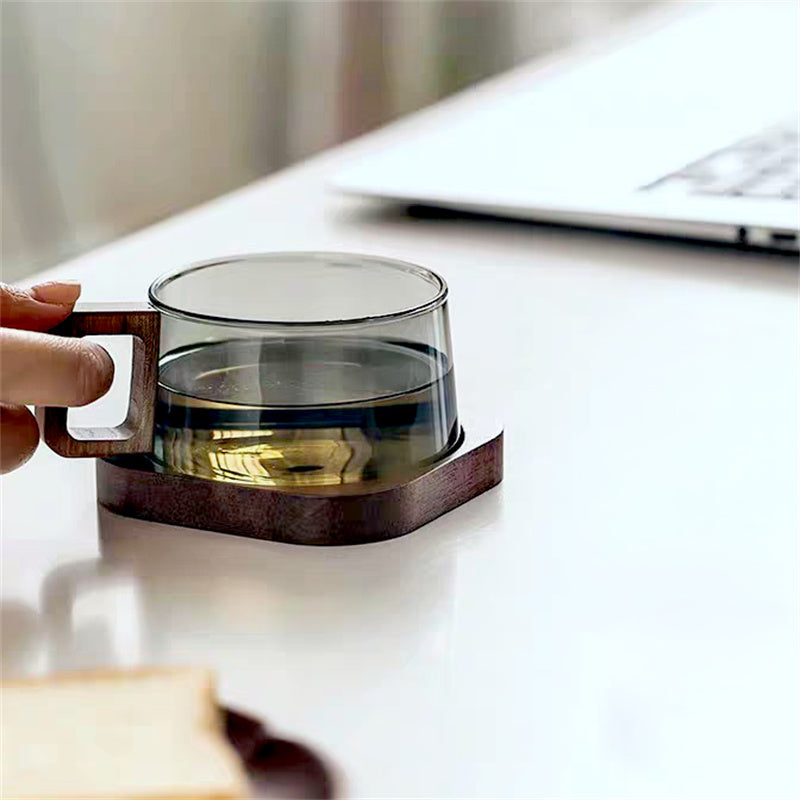 Stylish glass coffee mug featuring a unique cedar handle. Ideal borosilicate drinkware for kitchen & home.